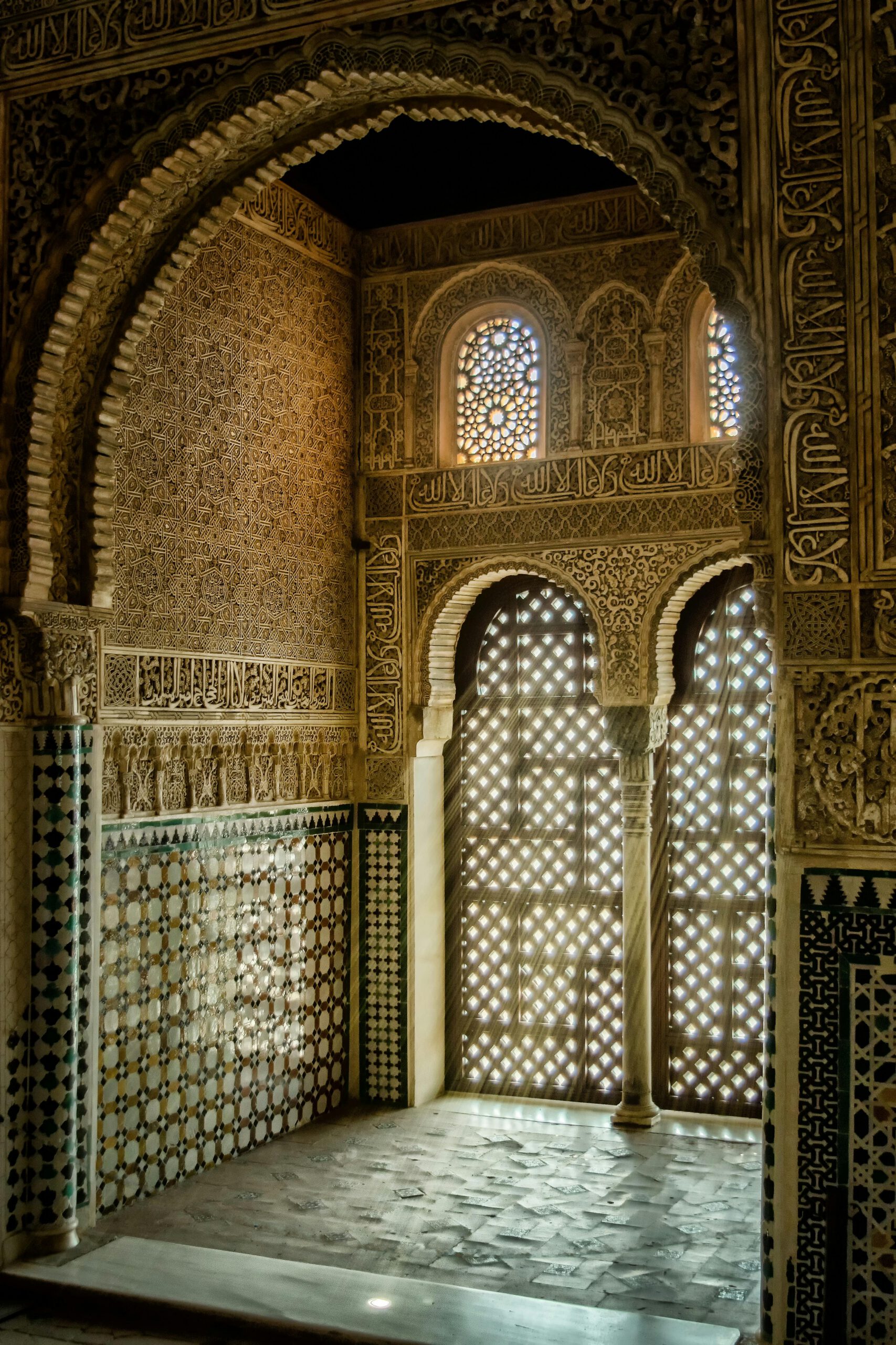 Stunning Moorish architectural design inside the Alhambra with intricate mosaic and stone work.
